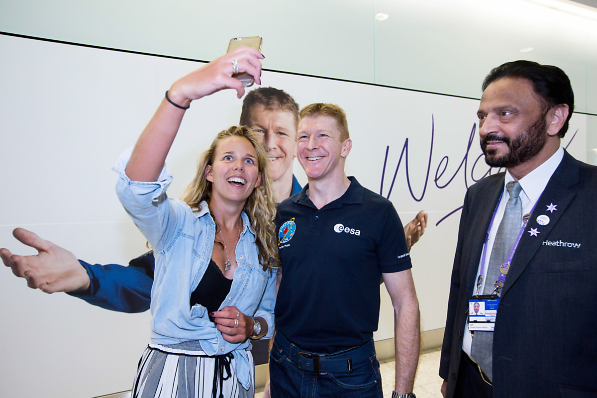 Download Image - Tim Peake with an excited passener picture