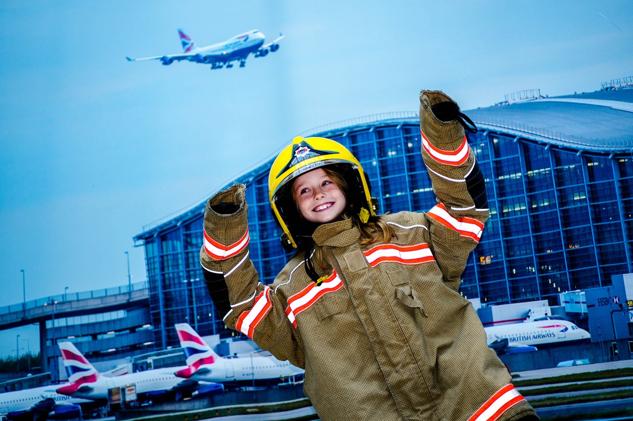 Imogen McLernon, 7, dresses up her dad's Heathrow firefighter uniform
