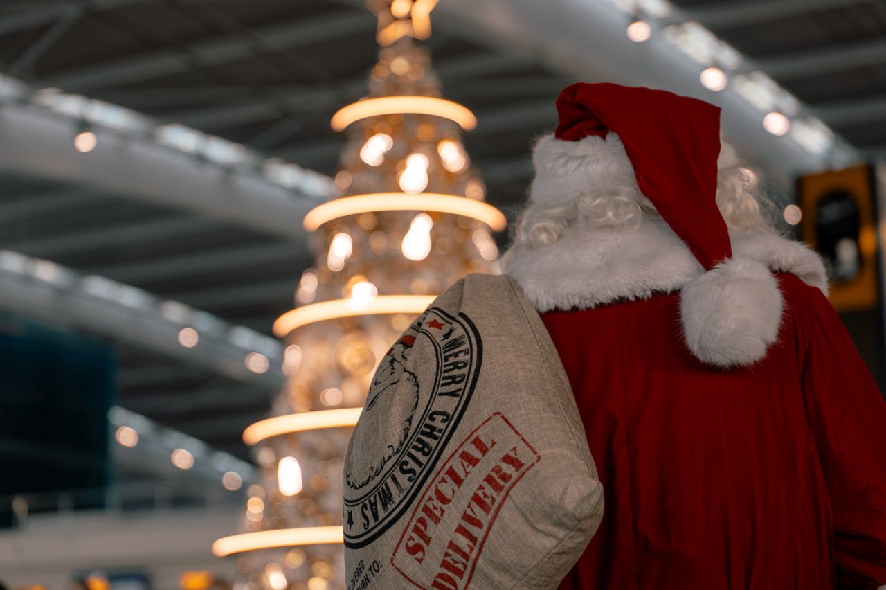 santa in front of tree